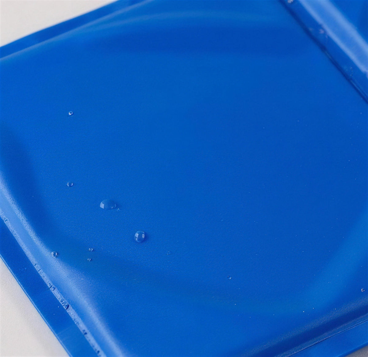 Close-up of the ChillMat surface with water droplets on the wipe-clean finish